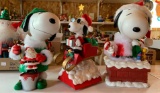 Group of three Peanuts Snoopy musical Christmas figurines