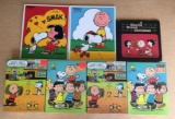 Group of 7 Peanuts Puzzles and a Book