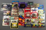 Group of die cast racing vehicles and more in original packaging