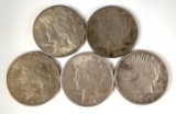 Group of five peace silver dollars