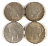 Group of four peace silver dollars