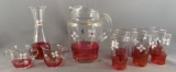Group of 10 ruby flash glass items with floral design