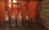Shelf lot of Vintage Glass Milk Jugs with wire racks