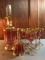 Group of antique Cabochon Moser cranberry glasses and decanter set