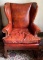 Vintage brown/red leather wing backed chair