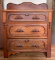 Antique wooden washstand with ornate carved pulls