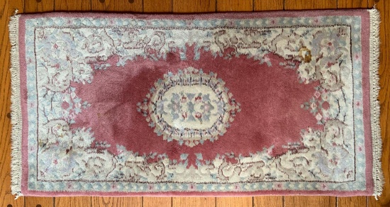 Antique rose colored oriental rug with floral design