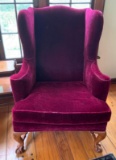 Burgundy upholstered wing back chair with ball and claw feet