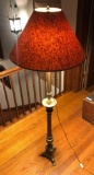 Vintage brass floor lamp with claw feet.