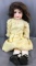 Antique bisque head doll with brown hair and eyeshadow