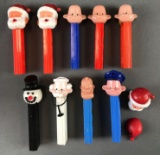 Group of 11 vintage no feed PEZ dispensers and pieces