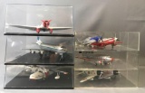 Group of 8 toy airplane replicas in display cases