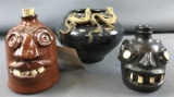 Group of stoneware face jugs and bowl