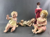 Group of vintage antique piano babies and doll