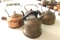 Group of four antique copper kettles