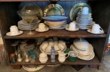 Large shelf a lot of miscellaneous dishes and clear glass