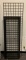 Group of 5 black grid wall panels and base.