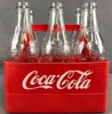 7 piece group clear glass Coca-Cola bottles in plastic carrier