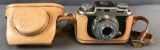Vintage 35mm camera with leather vase