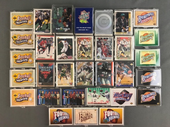 Group of 30+ plastic card cases holding assorted sports trading cards