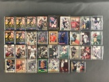 Group of 30+ plastic card cases containing NFL trading cards