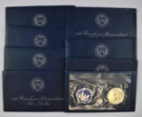 Group of (8) Eisenhower 40% Silver BU Dollars in Blue Envelopes