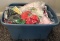 Plastic tote of assorted fabrics and doll accessories
