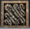 A framed collection of 130 Arrowheads in the Rattle Snake pattern, framed in wooden water stock barr