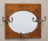 Antique oak, oval hanging beveled Mirror with 3 original fancy hat hooks.  Circa 1900-1910,  23 1/2