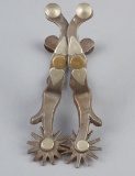 Pair of McChesney single mounted Spurs with chap guards.  Deanie Henderson Collection.