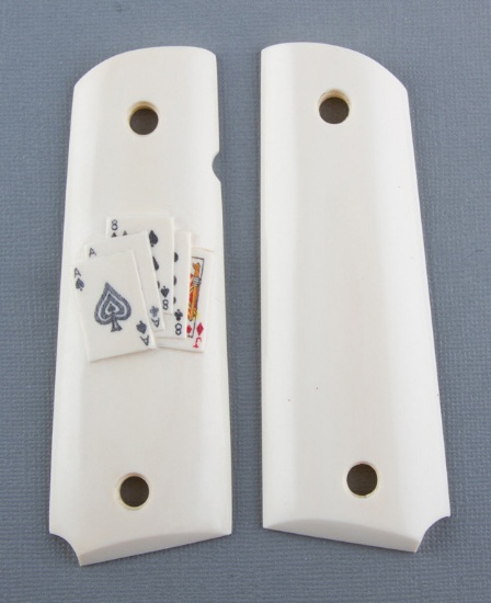 Pair of faux Ivory Grips for a Model 1911, right grip has raised card suits, excellent condition.