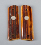 Pair of polished stag horn Grips for a Model 1911 Automatic, with inlaid Colt medallions.
