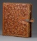 Fantastic carved leather Binder by noted artist, the late Bob Dellis, (1928-2002), 12