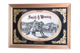 Framed, reverse painted on mirror advertisement for Smith & Wesson, 