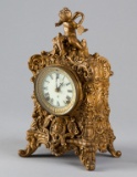 Ornate antique Cherub Parlor Clock by Ansonia Clock Co., in ornate footed case with cherub crest, 8-