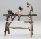 Bronze Pen Stand depicting an old wooden swing set with three young black children climbing on it.