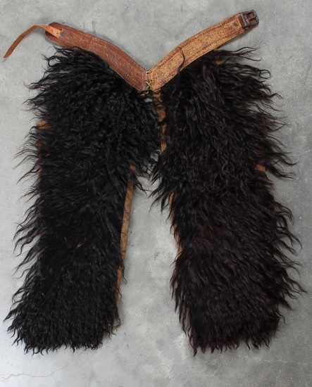 Pair of vintage black, child's Wooly Chaps with floral belt, canvas lined, approximately 26" long.