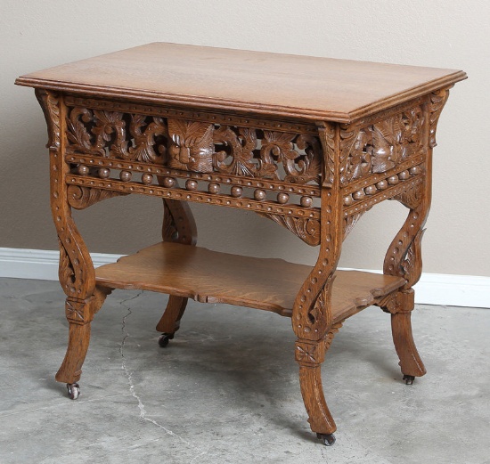 Very ornate, oak antique Parlor Table, circa 1910, with very ornate floral and stick & ball carved s