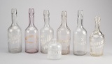 Collection of seven Saloon Advertising Bar Bottles with raised enamel lettering, ranging from 5