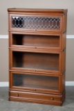 Antique oak four stack Lawyer Bookcase, circa 1900, made by Macey Co., with leaded glass top section