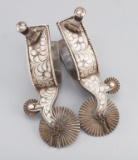 Fancy pair of single mounted, silver engraved Spurs marked  