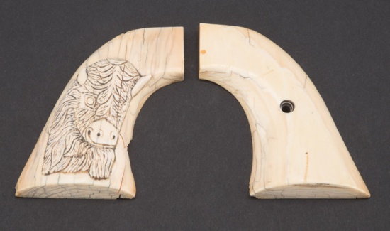 A pair of raised carved, two-piece ivory grips for a Colt SAA Revolver.  Right grip has carved Buffa