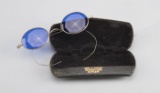 Pair of early Wire Rim Cheaters Glasses with curved blue lens in original folding case.  Case is mar