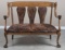 Fancy antique, quarter sawn oak Love Seat, circa 1910, in excellent finish and condition has lion he