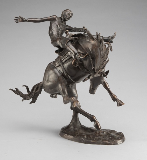 Two piece Bronze Western Sculpture of cowboy riding bucking horse, 22" T x 19" W, mounted on bronze