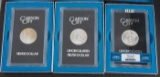 Group of three uncirculated Carson City Silver Dollars in matching boxes, two coins are dated 1882,