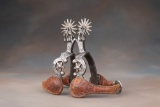 Pair of fancy single mounted Spurs attributed to E. Garcia with heart pattern and double jingle bobs