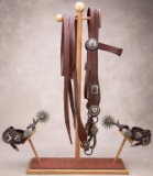 A unique wooden and tooled leather Bridle and Spur Stand marked 
