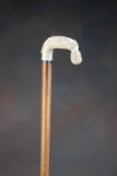 Vintage Cane with wooden shaft, and what appears to be an ivory carved Egyptian figural handle with