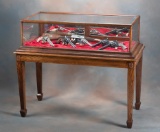 Antique, two piece, floor model oak sliding glass Display Case.  Top glass has 1